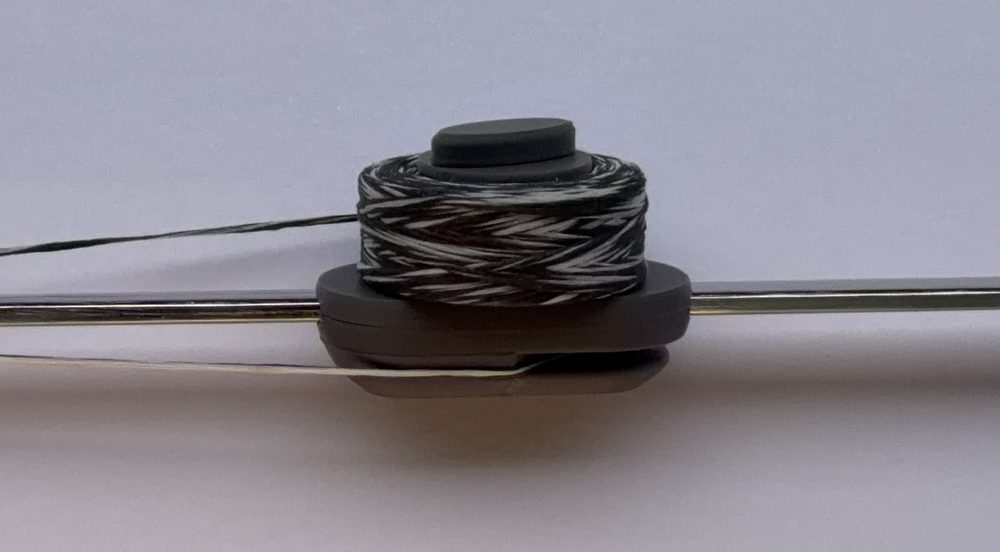 Close-up of the floss holder and spool